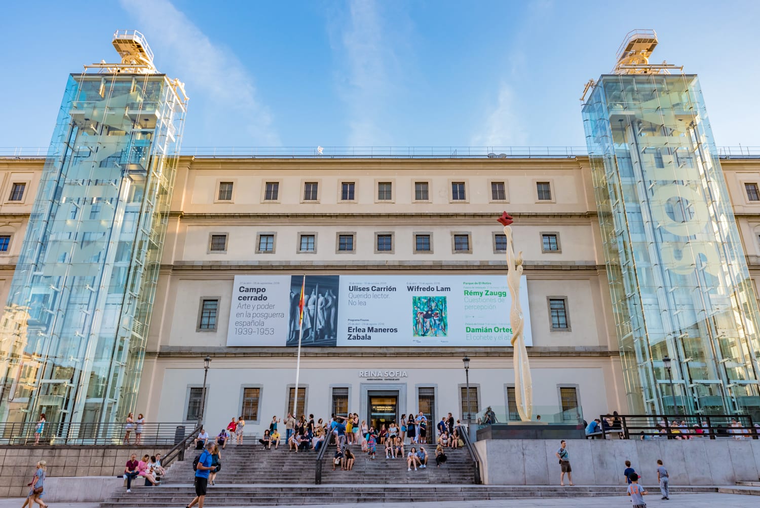 Reina Sofía Museum – Madrid’s modern and contemporary art museum Reina Sofía Museum in Madrid – modern art museum façade with glass elevators and visitors on the main staircase