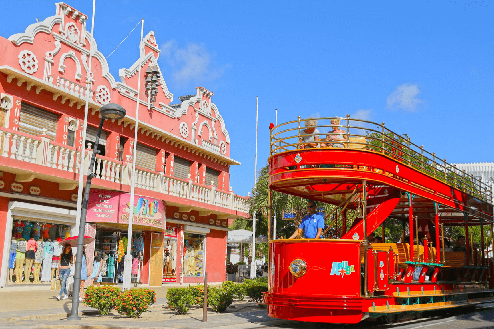 Oranjestad Streetcar – Exploring Downtown Aruba Oranjestad Streetcar passing colorful Dutch-Caribbean buildings in Aruba