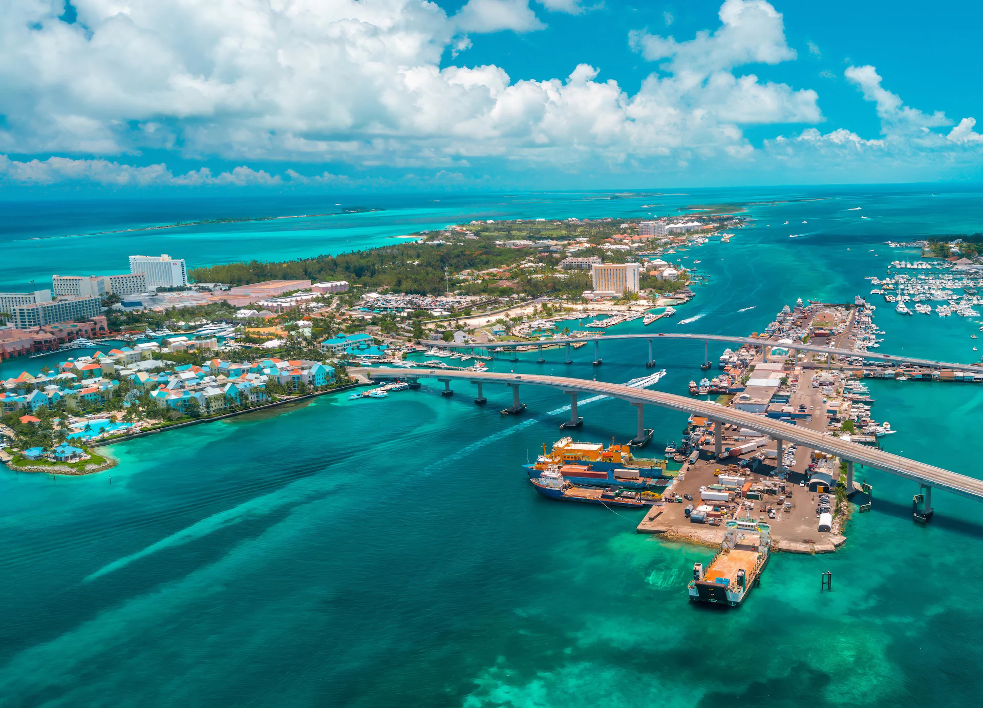 About Bahamas – Aerial View of Nassau and Paradise Island Aerial view of Nassau harbor and Paradise Island in the Bahamas with bridge, resorts and turquoise waters