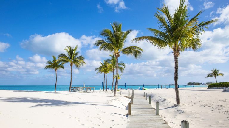 Bahamas Weather – Sunny Tropical Beach & Year-Round Climate Sunny tropical beach in the Bahamas with white sand, palm trees and turquoise sea under a blue sky