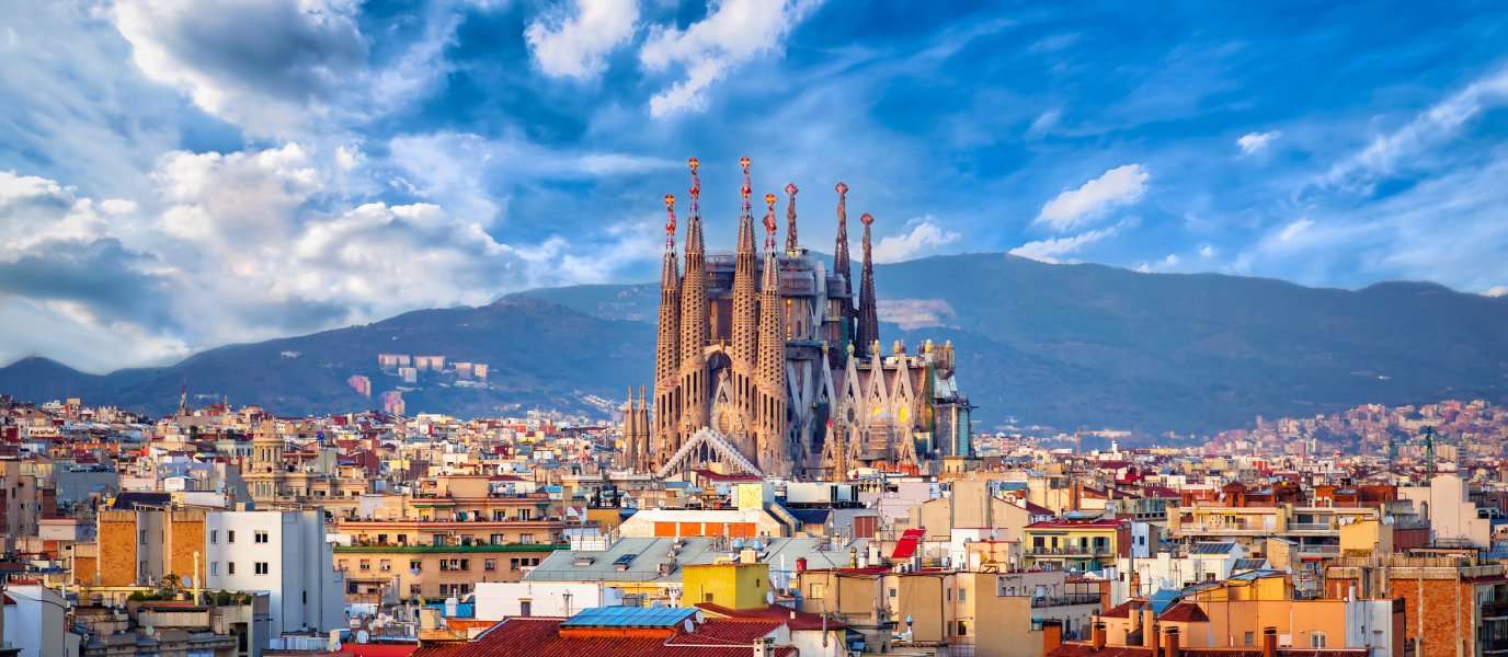 Top Destinations in Barcelona – Iconic Landmarks and Must-See Sights View of Sagrada Familia rising above Barcelona’s city rooftops with hills in the background