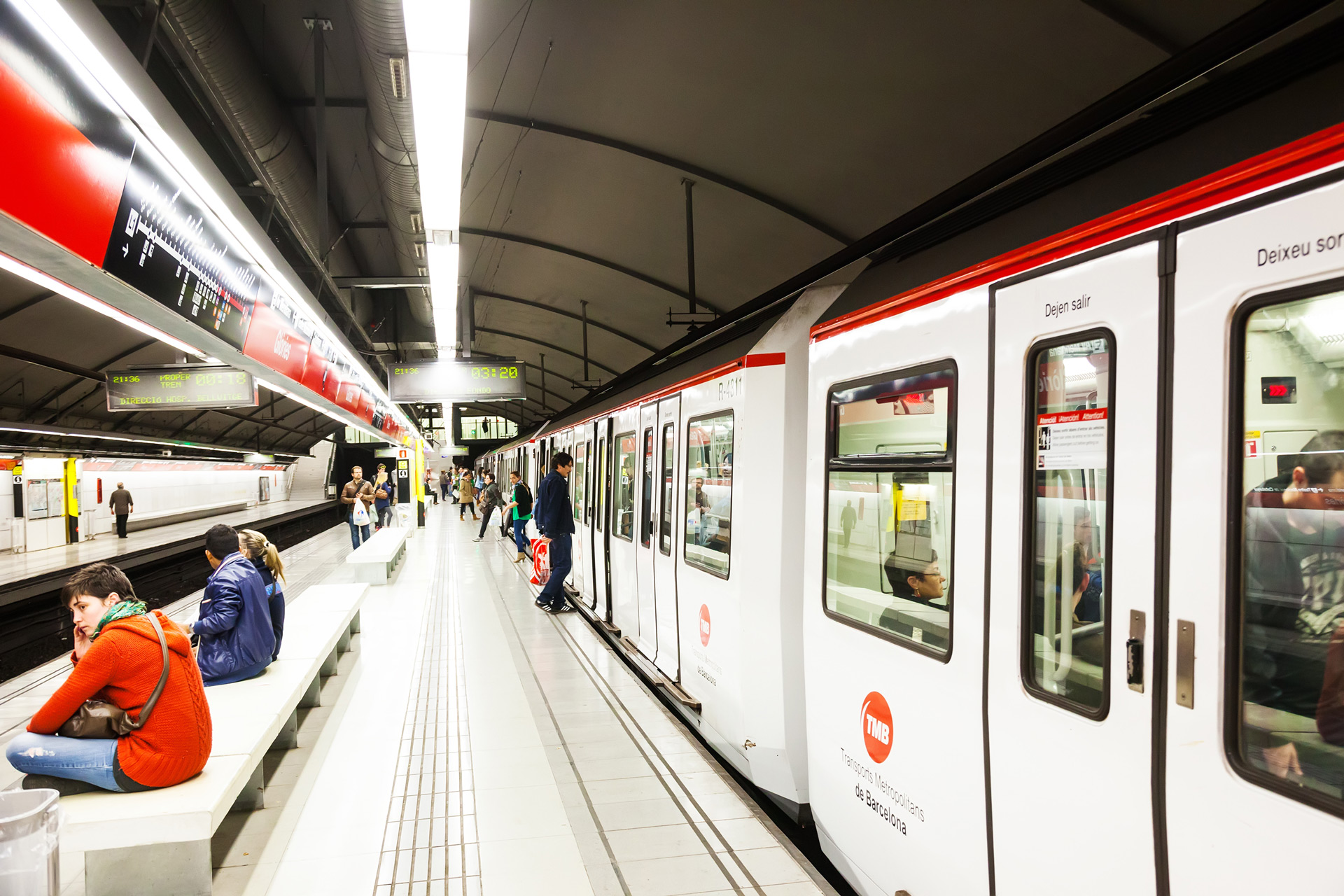 Getting Around Barcelona – Metro, Buses, Trams and Public Transport Tips Barcelona metro train arriving at a modern underground station with passengers waiting on the platform