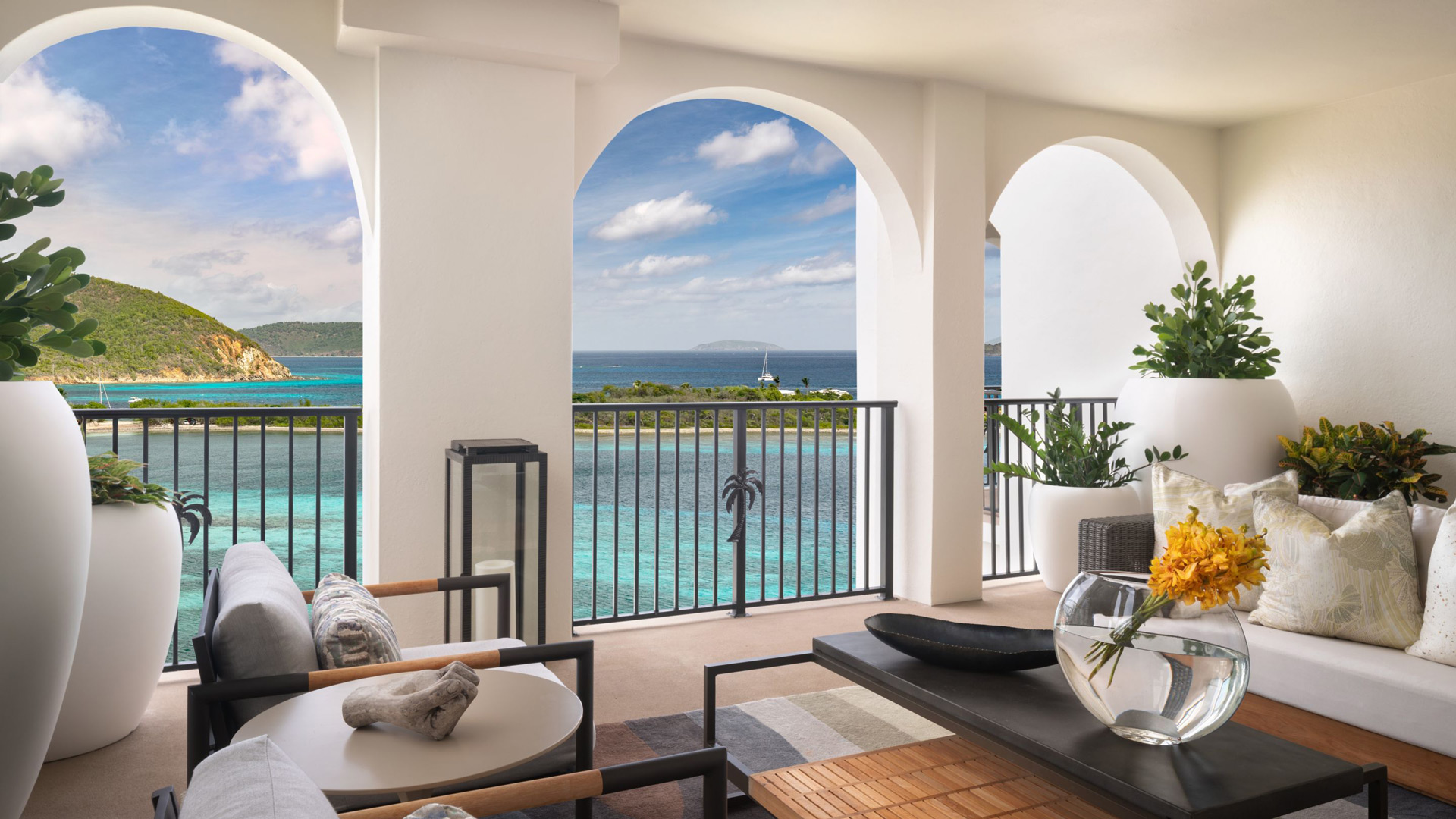 Hotels in the Virgin Islands – Oceanfront Resorts, Villas, and Island Stays Oceanfront hotel terrace with seating area overlooking turquoise waters in the Virgin Islands