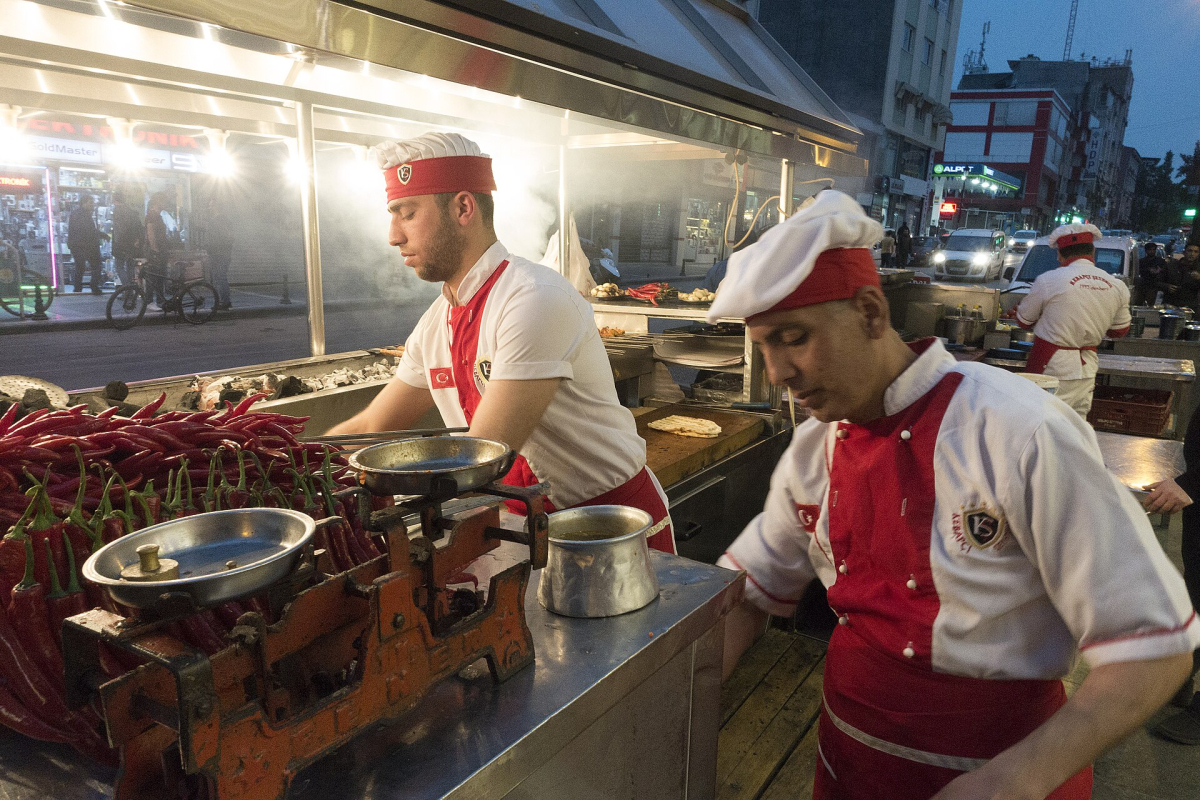 Cooks preparing Adana kebab on skewers Cooks preparing Adana kebab on skewers