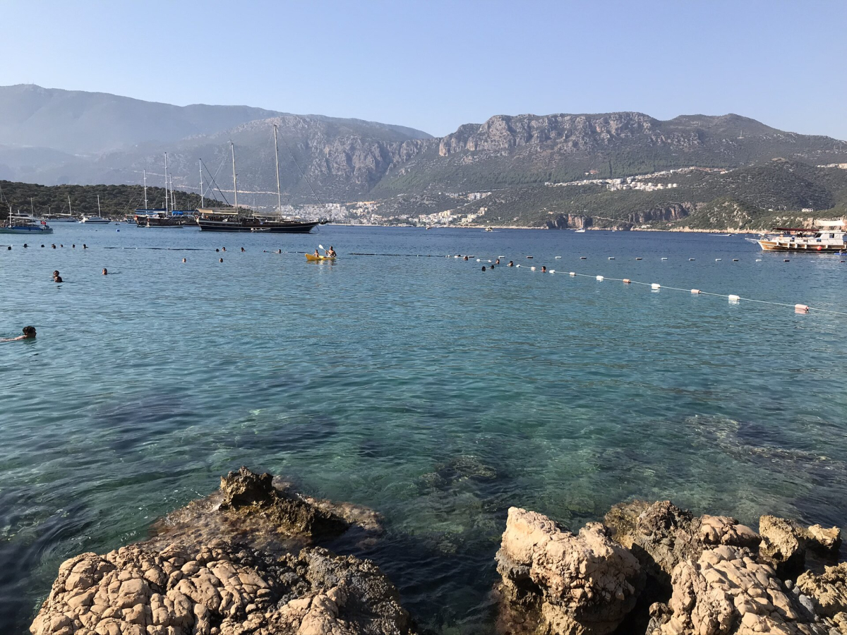Swimmers and boats in the clear water at Limanağzı near Kaş Swimmers and boats in the clear water at Limanağzı near Kaş