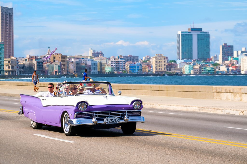 Classic American cars driving along Havana's Malecon
