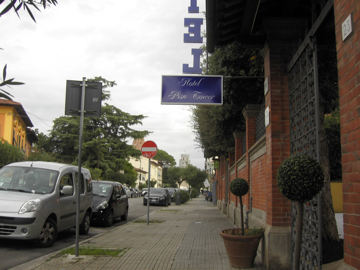 The signed entrance of Hotel Pisa Tower; confirm the building assigned to your booking. The signed entrance of Hotel Pisa Tower; confirm the building assigned to your booking.