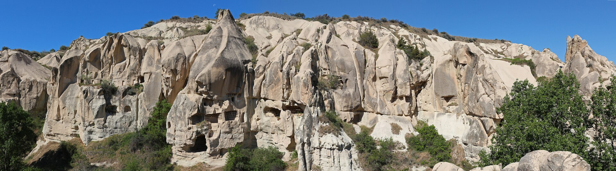 Rock-cut openings in the pale volcanic cliffs near Göreme in Cappadocia Rock-cut openings in the pale volcanic cliffs near Göreme in Cappadocia