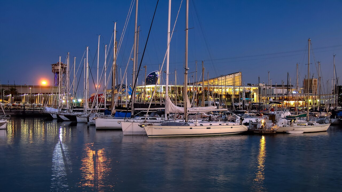 Sailing boats moored at Port Vell in Barcelona at dusk Sailing boats moored at Port Vell in Barcelona at dusk