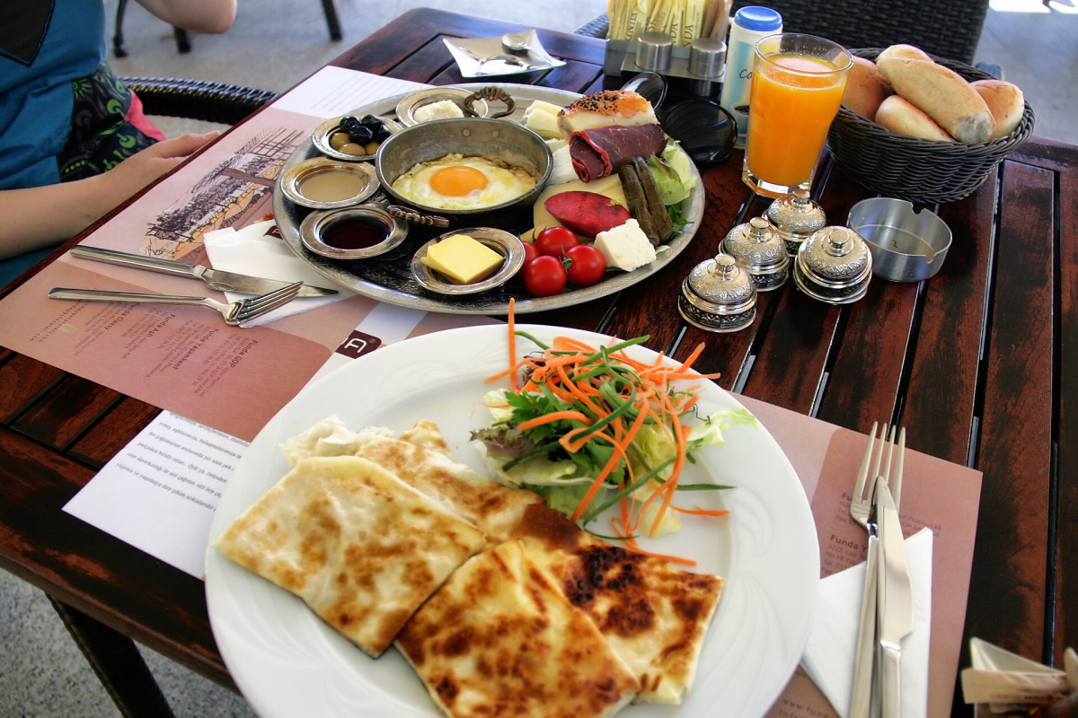 Turkish breakfast with eggs, cheese, olives, tomatoes and bread Turkish breakfast with eggs, cheese, olives, tomatoes and bread