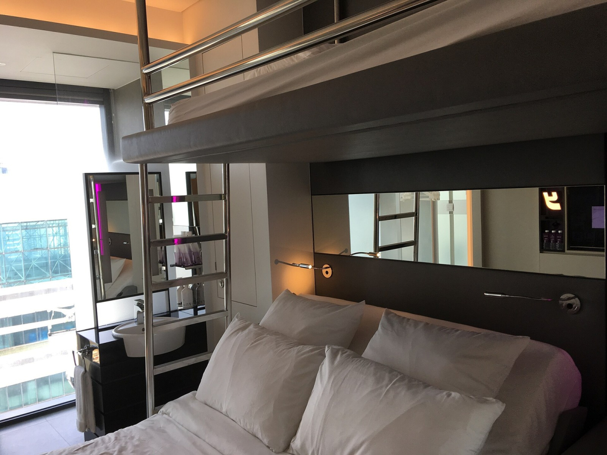 Room interior at YOTEL Singapore, photographed in 2018. Historical room example; the category is not identified and other room layouts may differ. Room interior at YOTEL Singapore with a bed and upper bunk