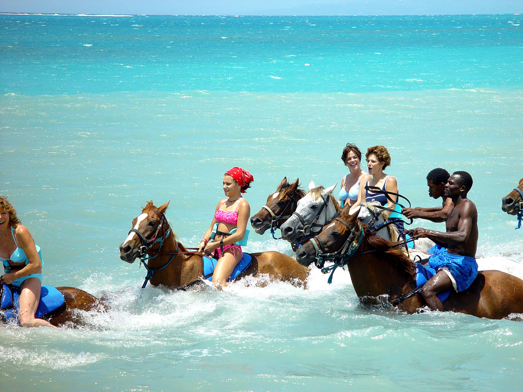 Things to Do in Jamaica – Horseback Riding in the Sea Travelers enjoying horseback riding in the sea in Jamaica, one of the island’s unique outdoor activities