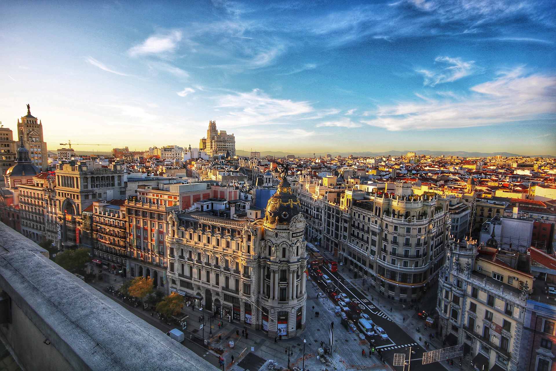 About Madrid – Culture, Architecture and City Identity Aerial view of Madrid’s Gran Vía and the Metropolis Building under a clear blue sky