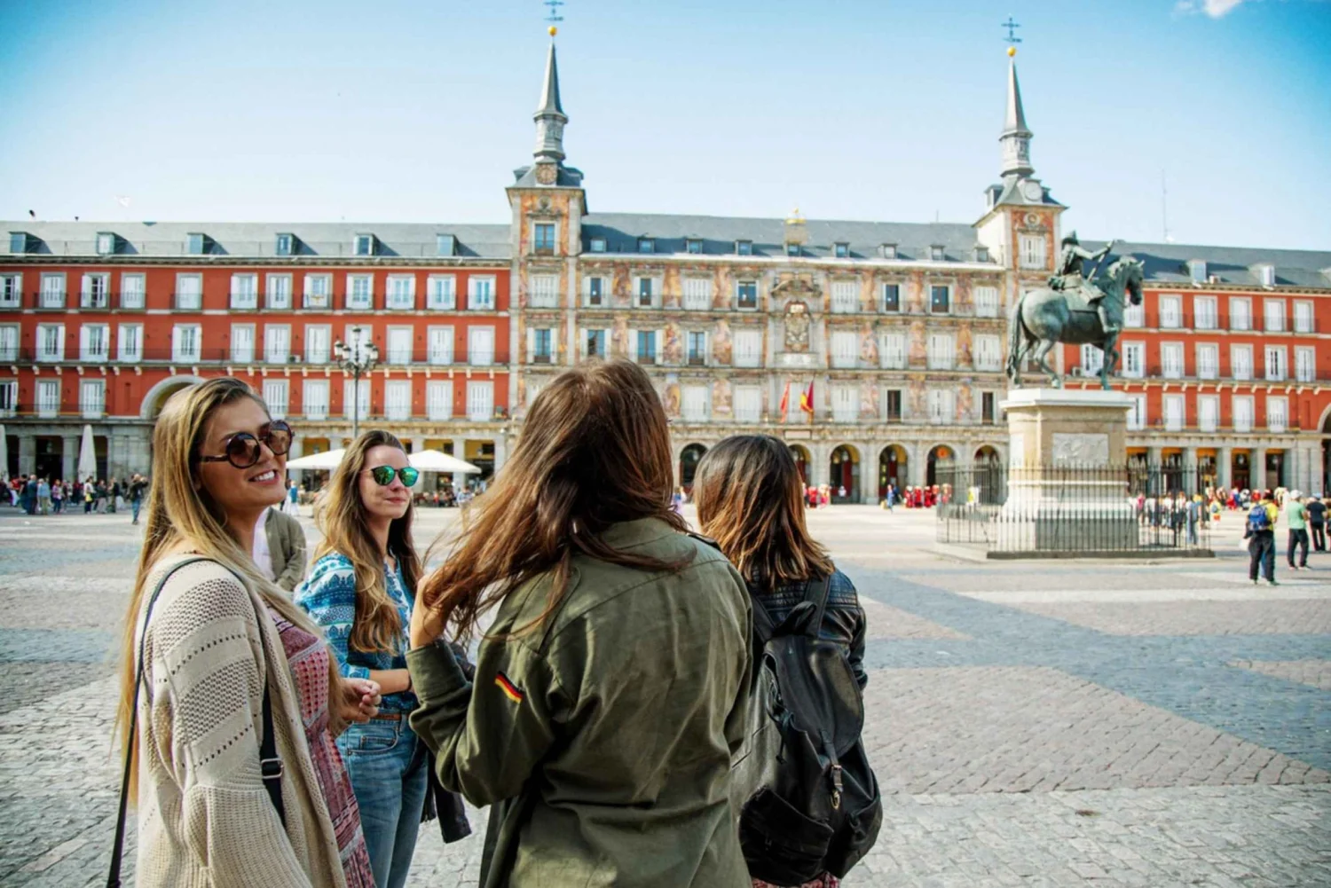 Madrid Travel Tips â Exploring Plaza Mayor Travelers exploring Plaza Mayor in Madrid on a sunny day