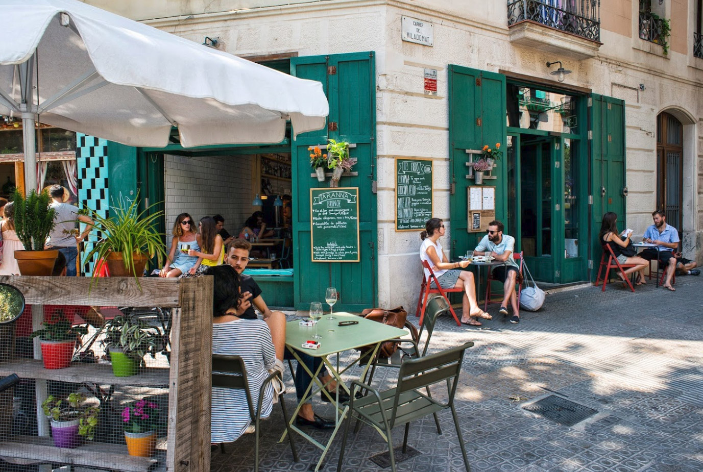 Everyday life in Spain – plazas, cafés and late-evening socialising Local people enjoying an evening on a Spanish plaza with cafés and historic buildings