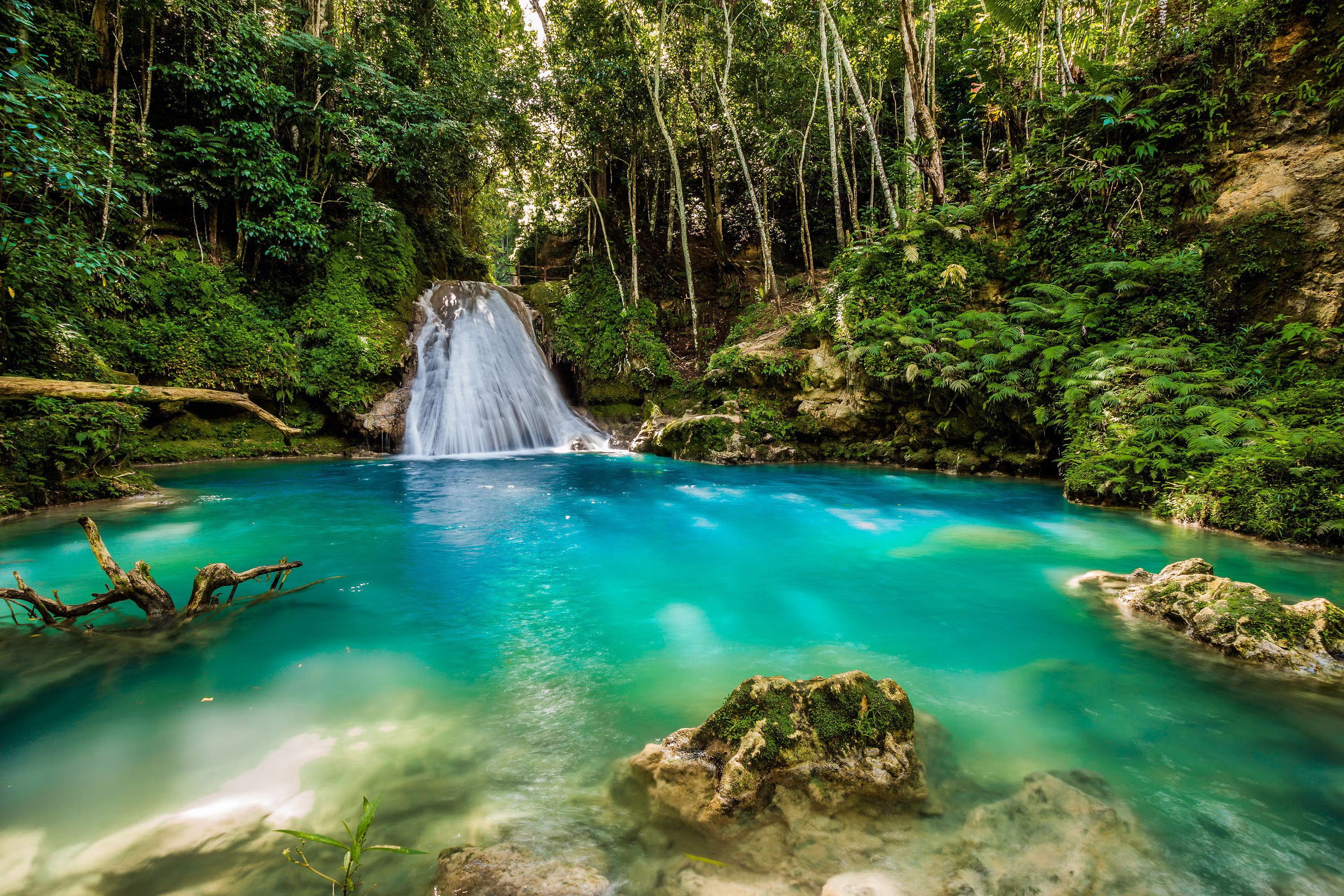Top Destinations in Jamaica – Where to Stay and What to Explore Tropical waterfall and turquoise lagoon surrounded by lush rainforest in Jamaica