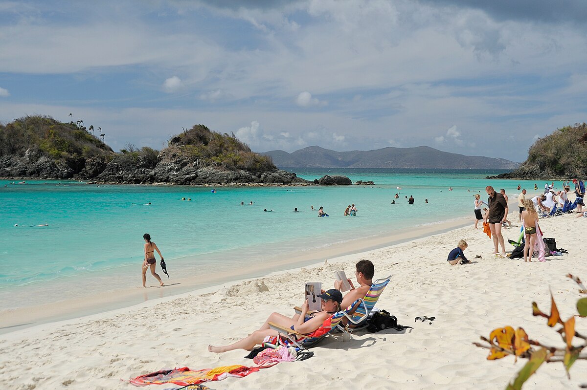 Popular white sand beach with calm turquoise water and visitors enjoying the shoreline in the Virgin Islands