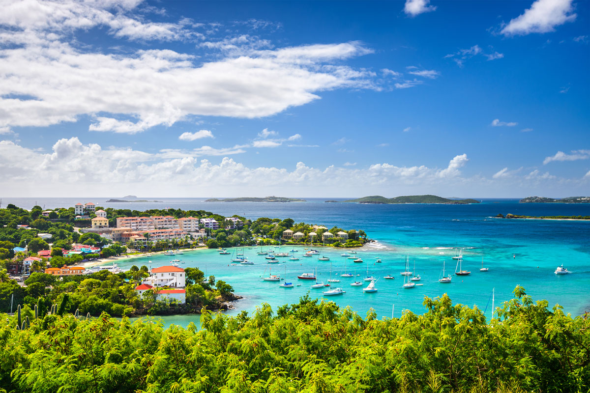 Virgin Islands Weather – Climate and Year-Round Conditions Typical weather conditions in the Virgin Islands with blue skies, light clouds, and calm coastal waters